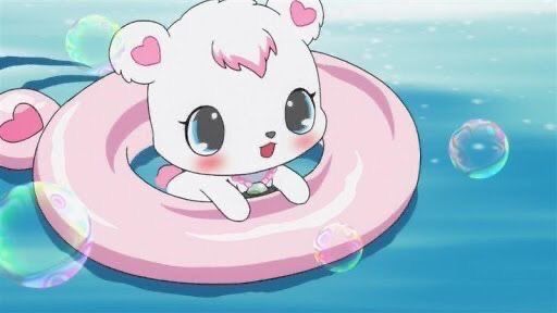 Labra, a small polar bear character from the Jewelpet series with blue eyes and heart shapes inside her ears, is happily floating in water with a pink inflatable tube with bubbles around her; not my image or my character, likely acquired via Twitter or Pinterest, credits to the makes of the Jewelpets