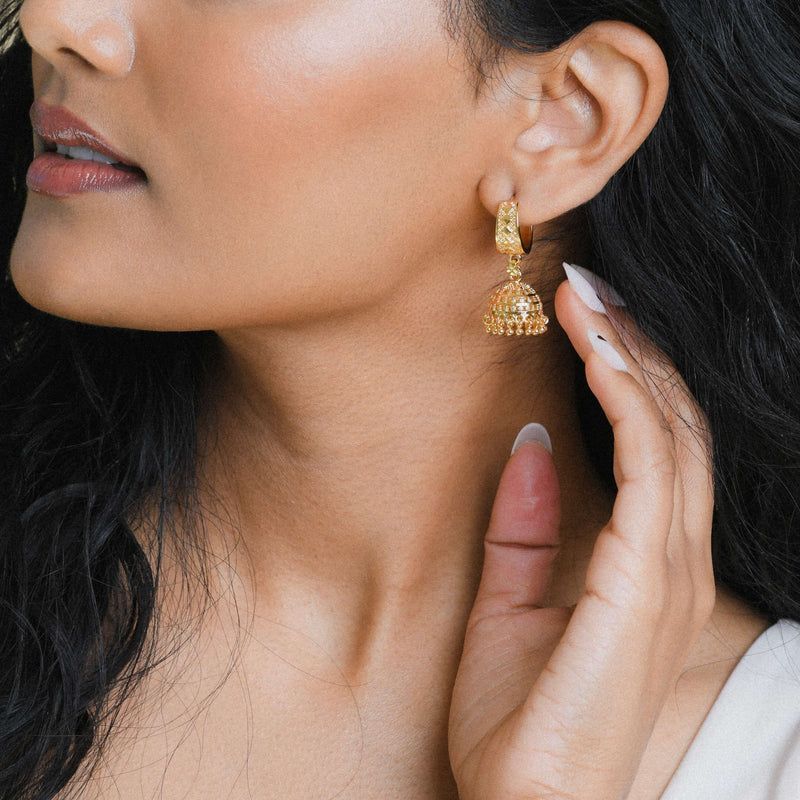 An image of a desi woman with long black hair modeling the baby jhumka earrings as featured on the BySimran website; not my photo, this image is featured on the BySimran website, all credits to BySimran and their models 