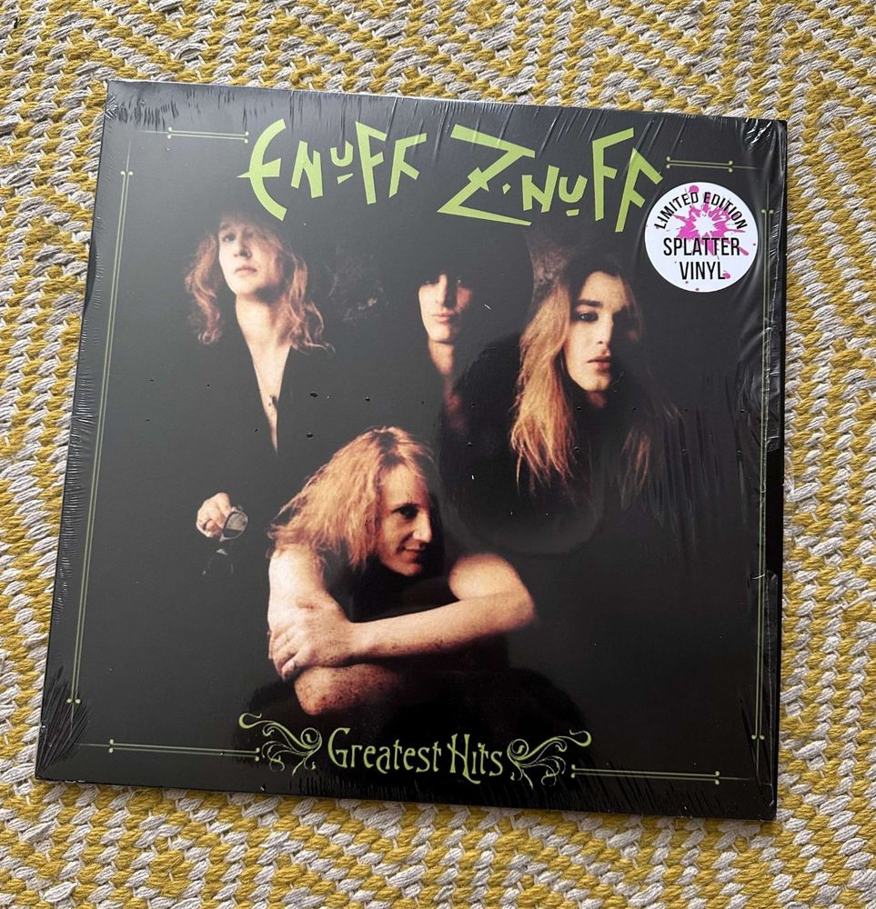 Cover of the Greatest Hits albums by Enuff Z'Nuff.  Picture is of the four hairy band members against ablack background.