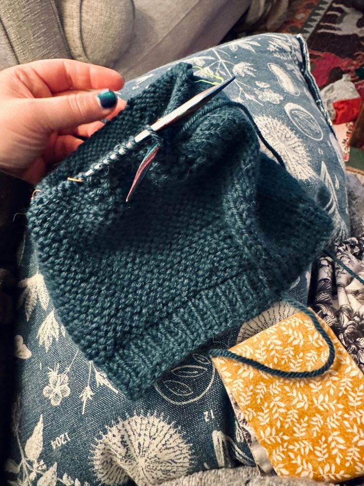 a lil teal hat WIP on circular needles, pattern is Barley from tin can knits