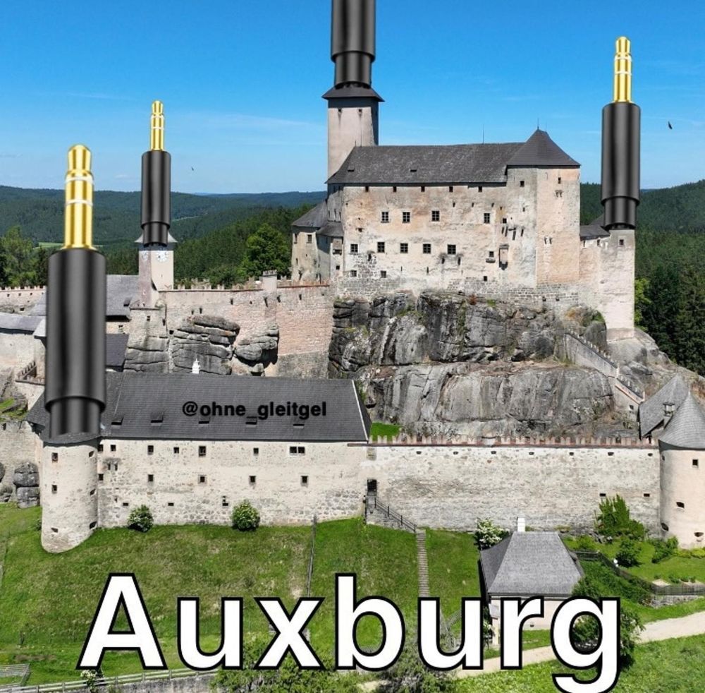 Meme "Auxburg". Ein Schloss mit Klinkenkabeln verziert.