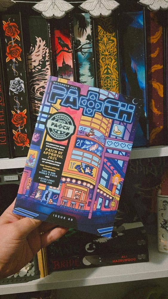 November 2025 patch magazine in front of a colourful bookshelf