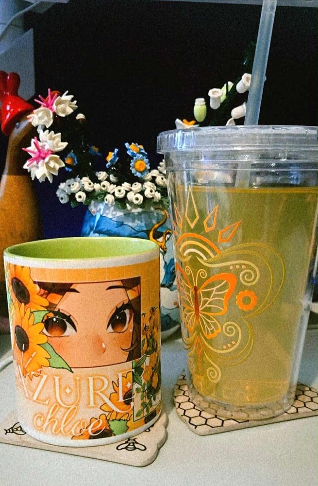 a picture of a mug with chloe's flower panel art one, and a drinks tumbler with chloe's logo on