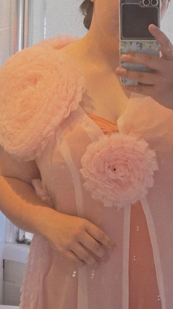 A mirror selfie of chloe in glindas nightgown 