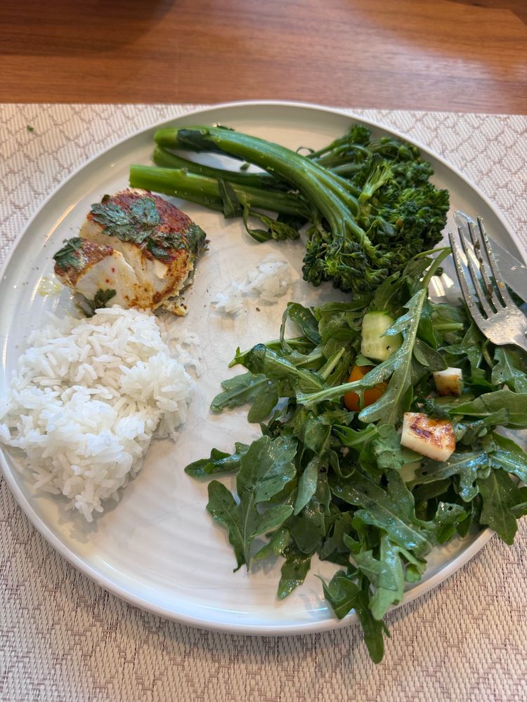 Fish on a plate with rice and vegetables