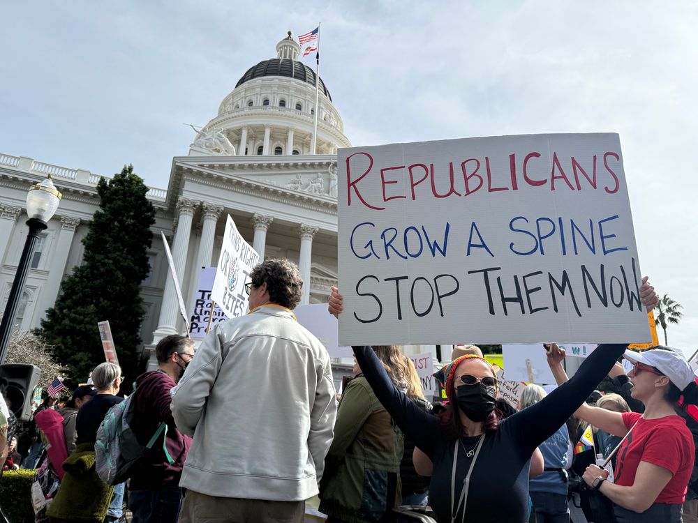 Protest at California’s capital in Sacramento-Protester holding a sign that says “Republicans grow a spine. Stop them now.”