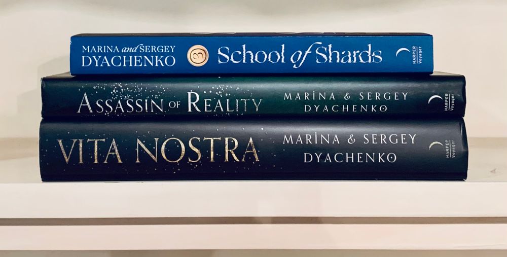 Pictured are the spines of the three books in the Vita Nostra trilogy in English translations: Vita Nostra, Assassin of Reality, and School of Shards.