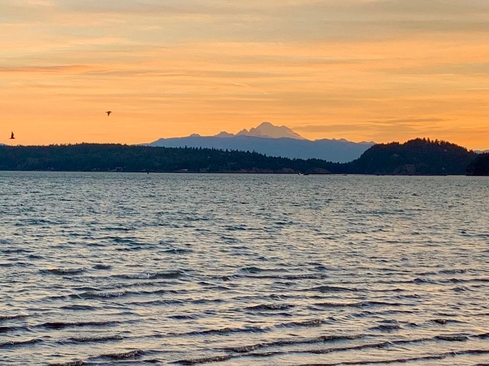 Peach colored sky, Mt Baker in the distance. Dugualla Bay across to mouth of Skagit River. 