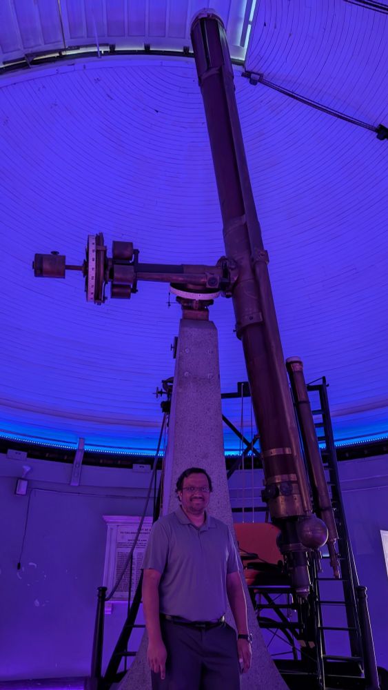 Photo of me standing on front of a giant 16 inch refractor. 