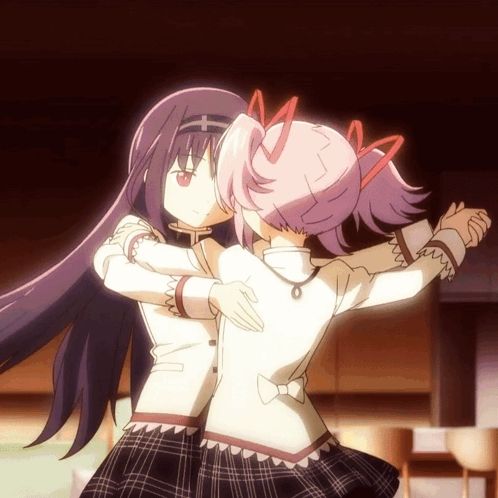 two anime girls are hugging each other and one has a cross on her head