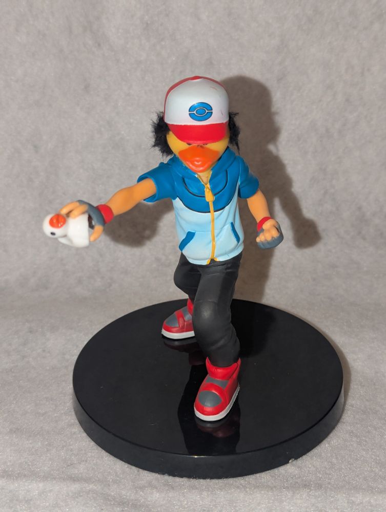 Ash Ketchum with a duck face and holding a duck