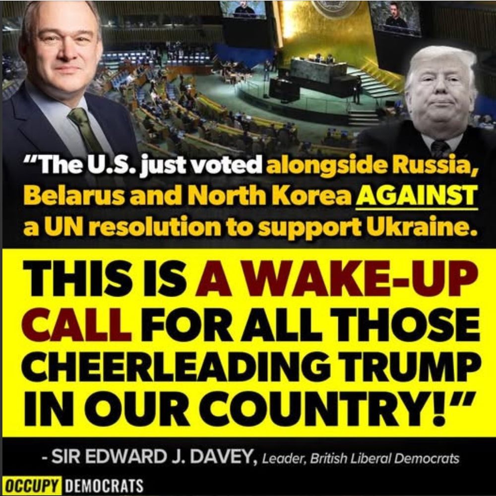 A political graphic from Occupy Democrats features a quote attributed to Sir Edward J. Davey, Leader of the British Liberal Democrats. The quote states, "The U.S. just voted alongside Russia, Belarus, and North Korea AGAINST a UN resolution to support Ukraine." Below, in bold yellow and red text, the graphic reads, "THIS IS A WAKE-UP CALL FOR ALL THOSE CHEERLEADING TRUMP IN OUR COUNTRY!" The background includes an image of the United Nations General Assembly with a screen displaying Ukraine’s President Zelensky, as well as photos of Ed Davey and Donald Trump. The design uses black, yellow, and red colors for emphasis.