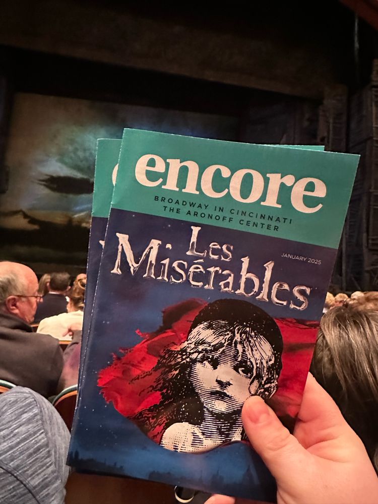 Photo of the Encore program from Les Misérables in front of the stage