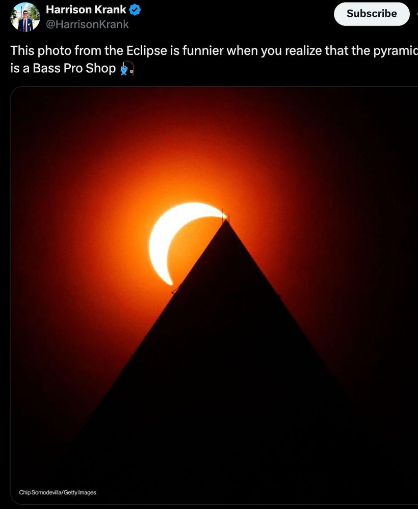 Tweet with a picture of a partial solar eclipse where the sun looks like it's hanging on the top of a pyramid. The text accompanying the picture is "This photo from the Eclipse is funnier when you realize that the pyramid is a Bass Pro Shop [fishing emoji]"