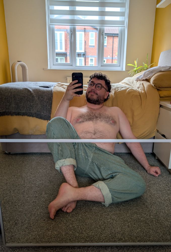 Another pic of the author topless and sitting on the floor