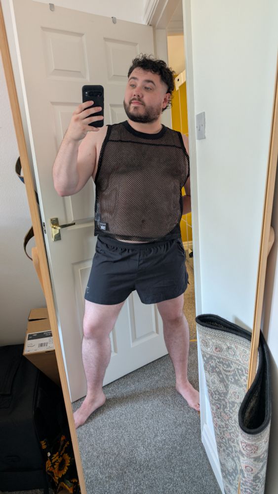 Author in a mesh vest and shorts