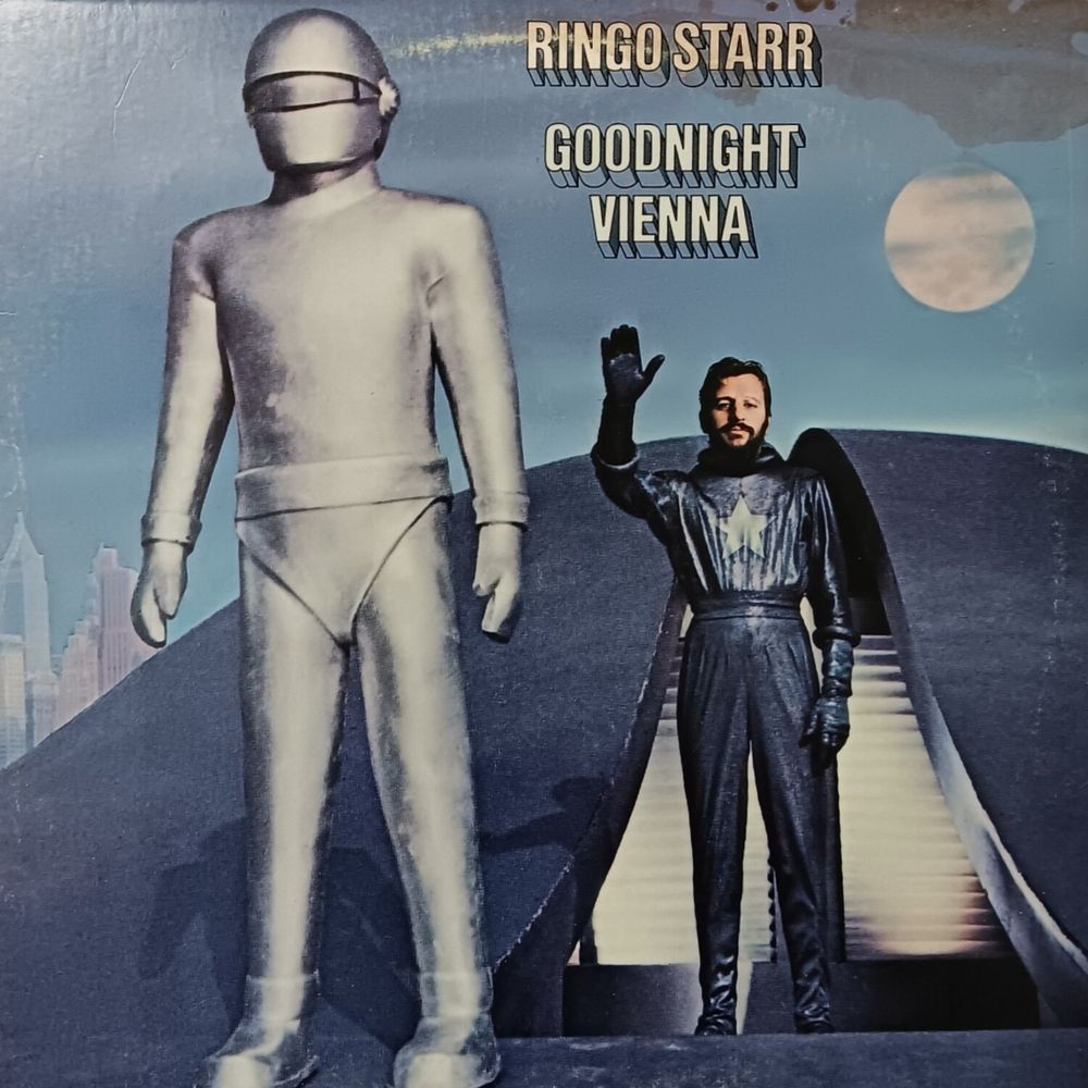 Ringo Starr Goodnight Vienna album. It shows the scene in the 1951 science fiction film The Day the Earth Stood Still, with Starr's head replacing that of actor Michael Rennie shown standing behind the robot Gort. They are both standing on a flying saucer.
