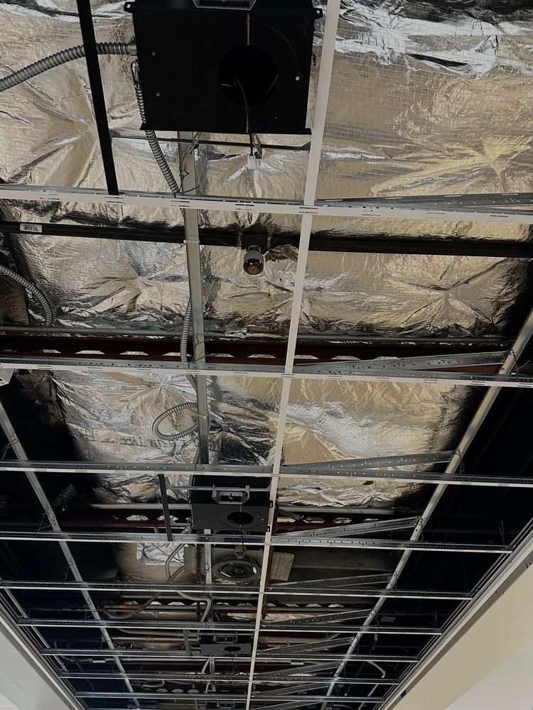 Ceiling HVAC and insulation in ceiling are shorn of its drop ceiling panels