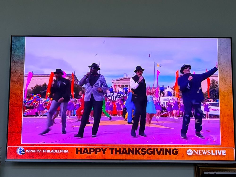 The Four Tops performing on a colorful street at the Philly T-Day Parade