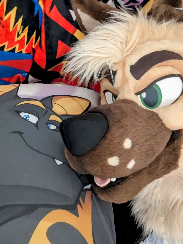 Me in fursuit laying down with a daki of Neferu
