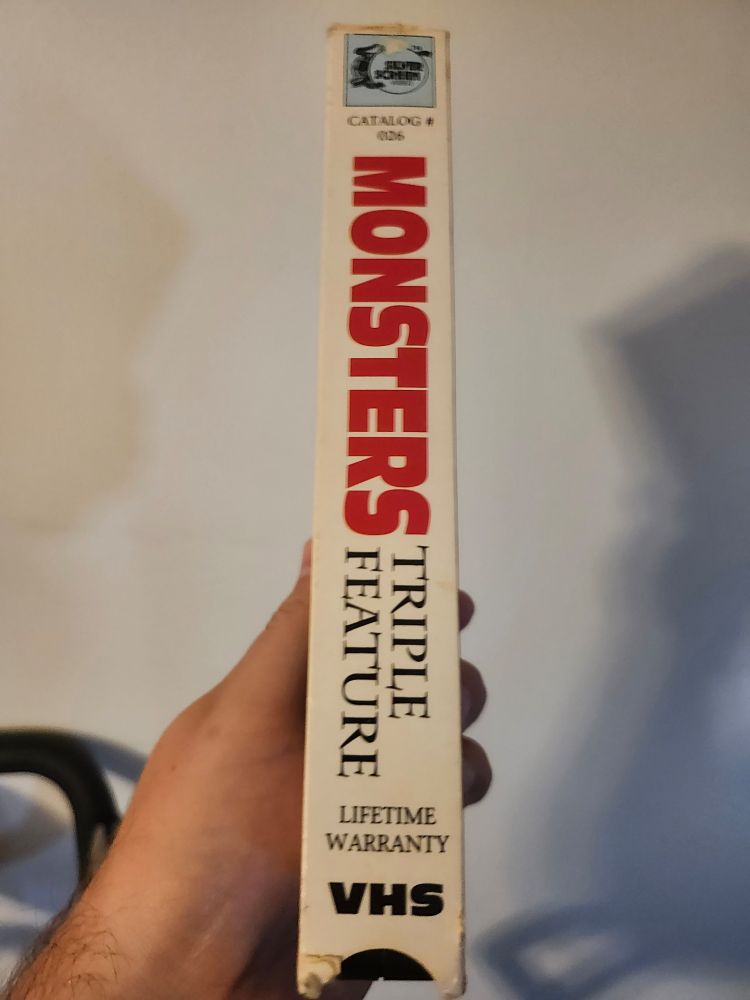 Side of VHS box that says monsters triple feature. Also says lifetime warranty 