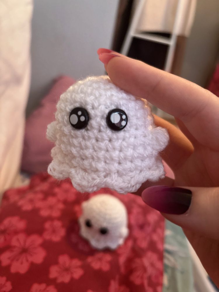 Bobbie is holding a little crochet ghost.