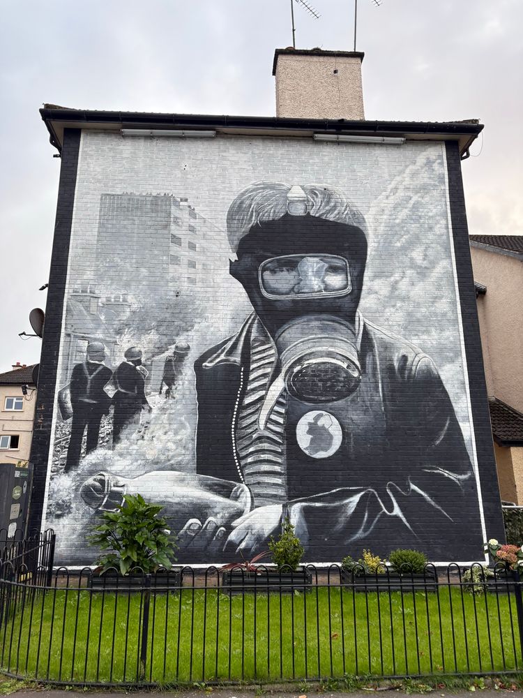 Mural in Derry of a child with a gas mask on during the troubles.