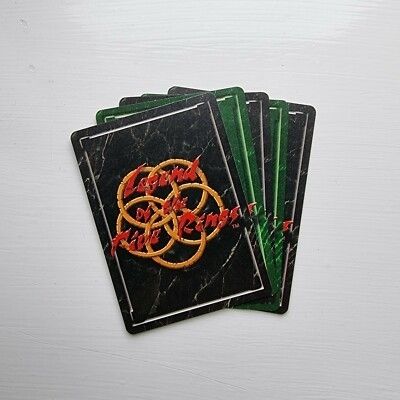Legend of the Five Rings Collectible Cards. Cards are black and green marble effect with the logo of the game. 