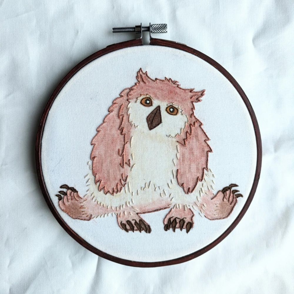 A hand embroidery piece depicting the Owlbear cub from Baldur's Gate 3 