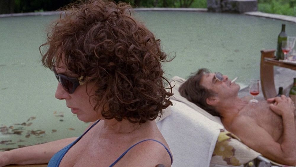 A wife and husband by their filthy-ass pool, shortly before the famous SCCCCCRRRRRRTTTTTTTTCCCHHHHH shot.
