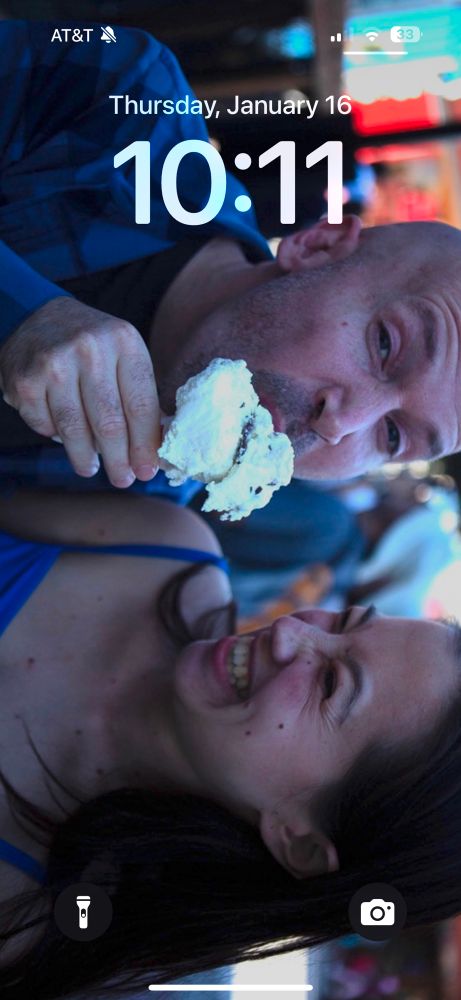 My Lock Screen features one of the engagement photos with my fiancée giving her cutest smile (where she somehow elucidates both joy and amusement) while I bite into a Coppa ice cream we picked up at a carte downtown.