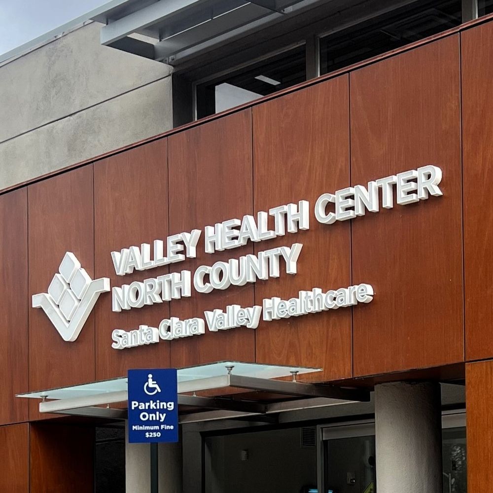 The outside of a two story building. The writing on the building reads - Valley Health Center North County - Santa Clara Valley Healthcare