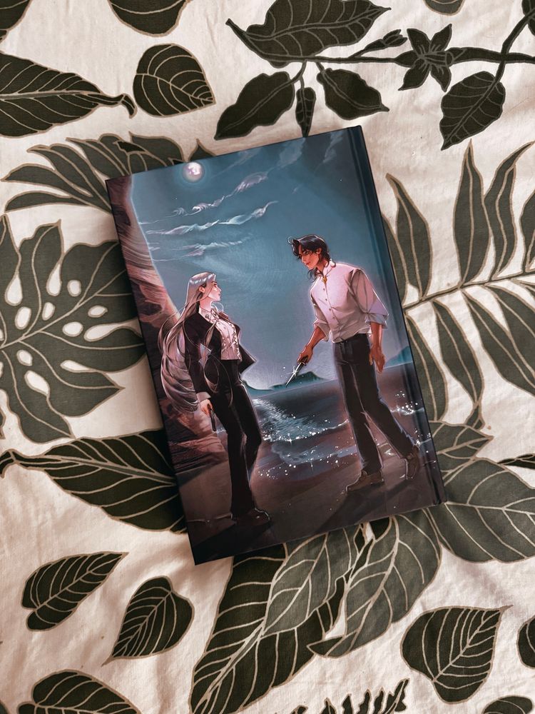 Owlcrate edition of Red City by Marie Lu- naked hardcover back shows two different characters on a beach at night standing across from each other, looking at each other. The man is holding a knife. 