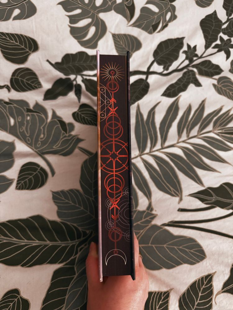 Owlcrate edition of Red City by Marie Lu edges are black with red and white and gold geometric designs 