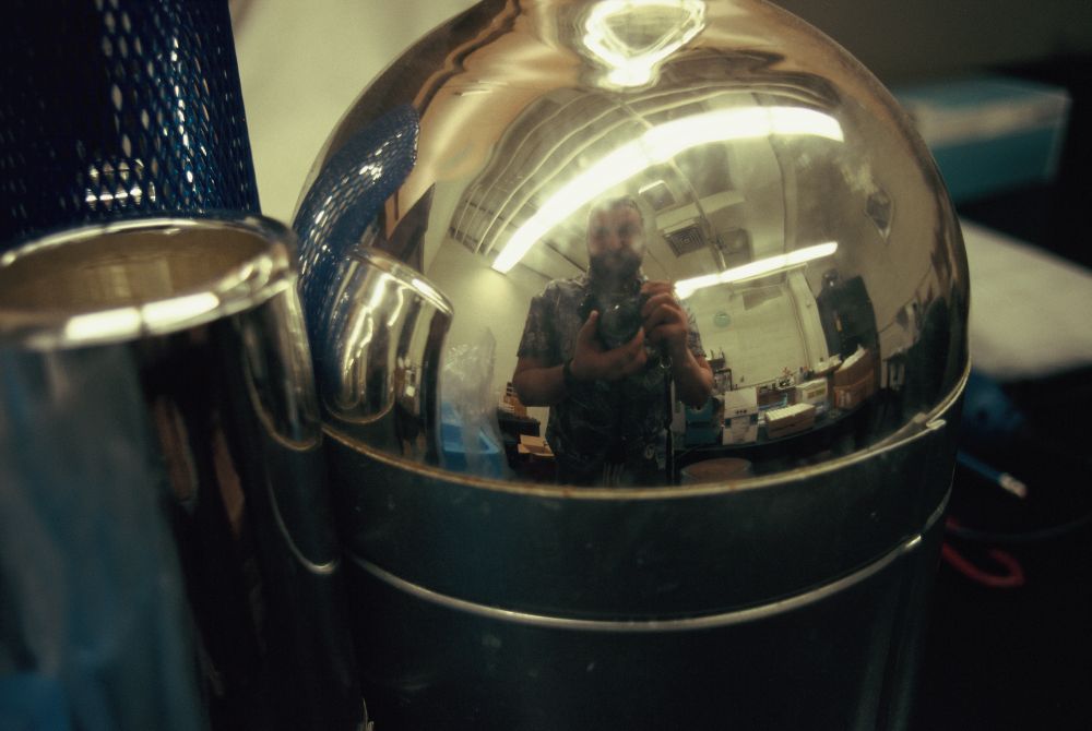 Reflection of the photographer in a liquid nitrogen dewar.