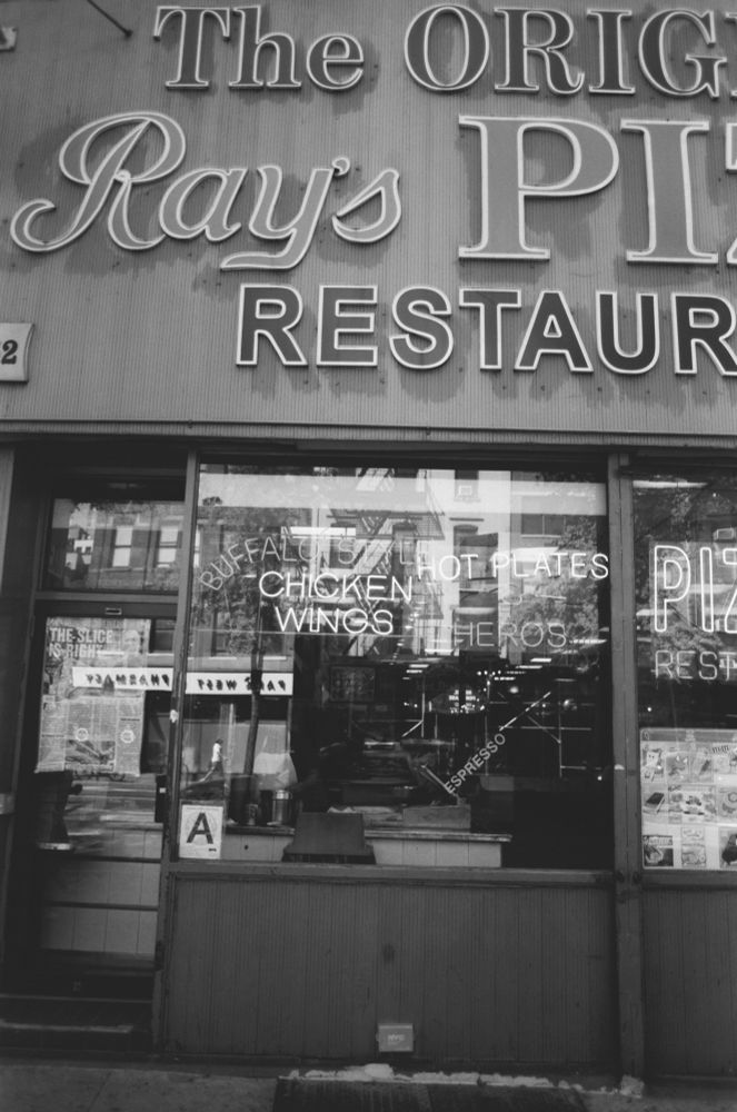 Black and white photograph of a restaurant in NYC. 