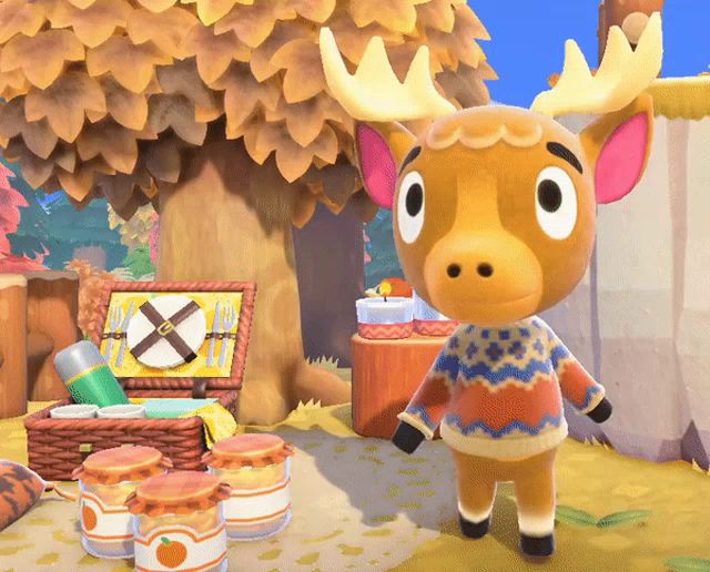 a moose wearing a colorful sweater is standing in front of jars of jam