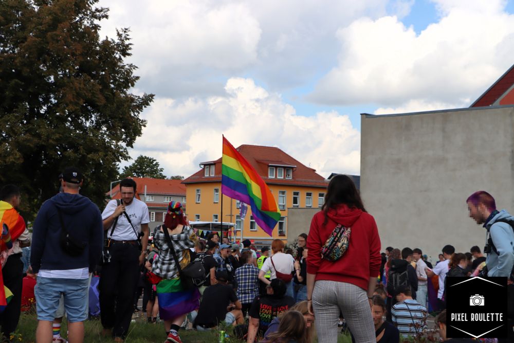 Übersichtsaufnahme des CSD Freibergs mit einer Regenborgenfahne im Zentrum.