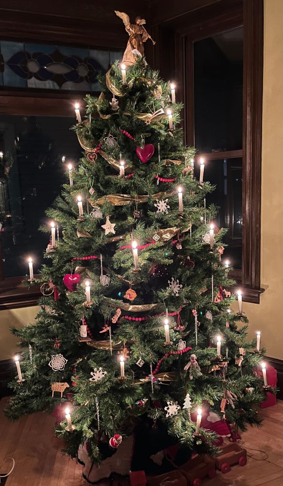 Christmas tree with real candles glowing