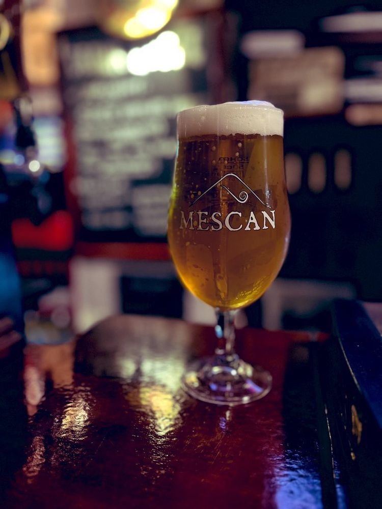 A pint of Mescan’s Seven Virtues lager testing on a bar
