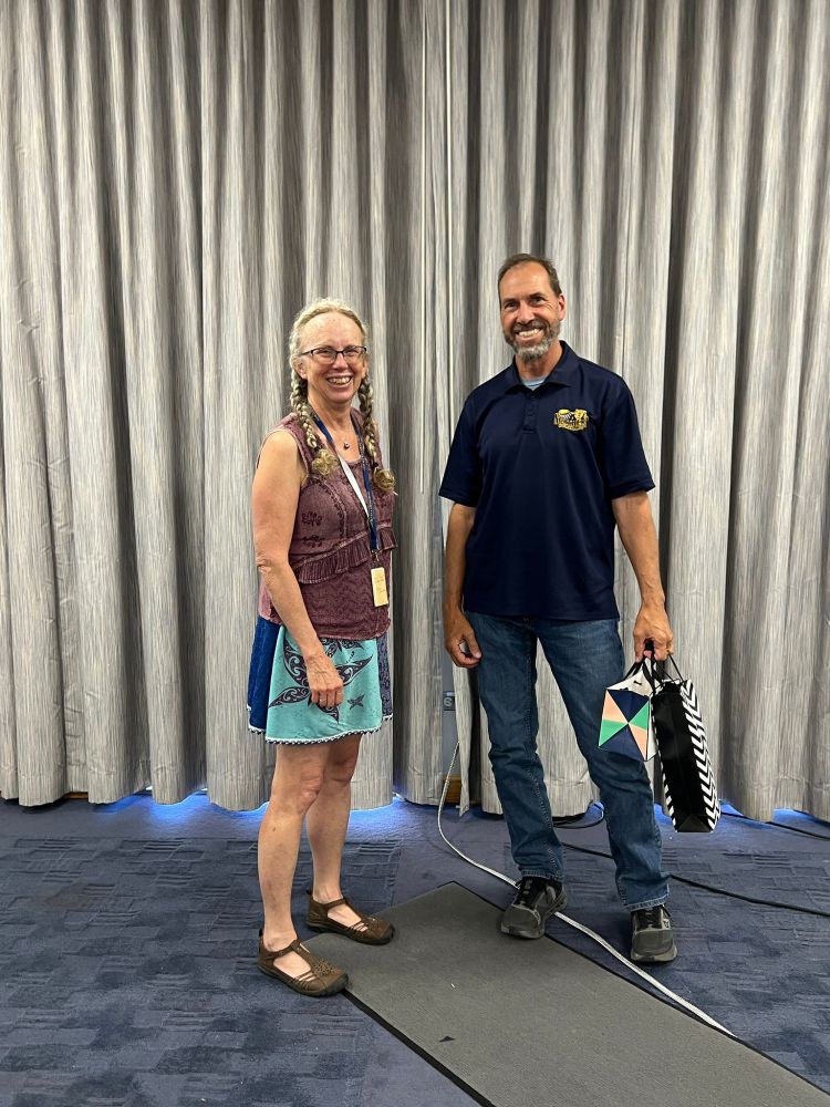President of the IAVS Susan Wiser and Symposium organizer Scott Franklin smiling at the camera at the closing ceremony.