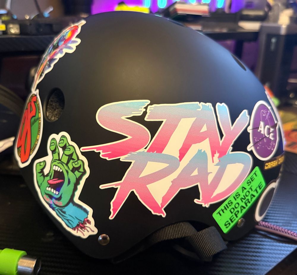 A skate helmet covered in stickers. 