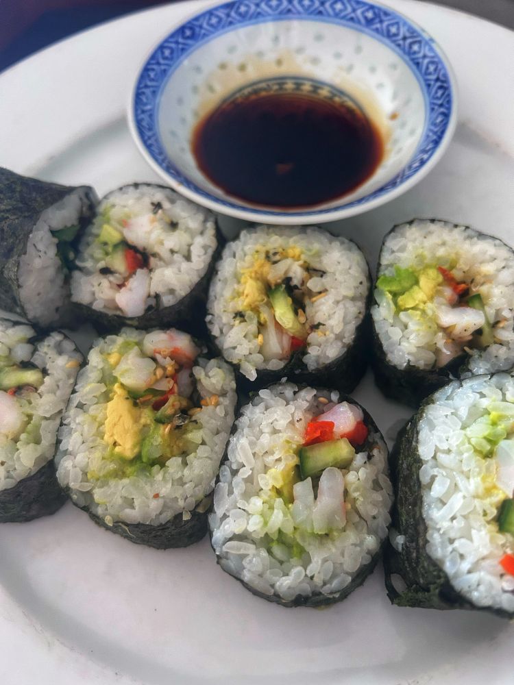 Homemade maki sushi rolls with shrimp, 
 avocado and cucumber.