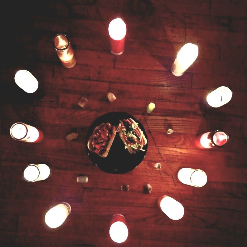 two hotdogs surrounded by crystals and a circle of candles