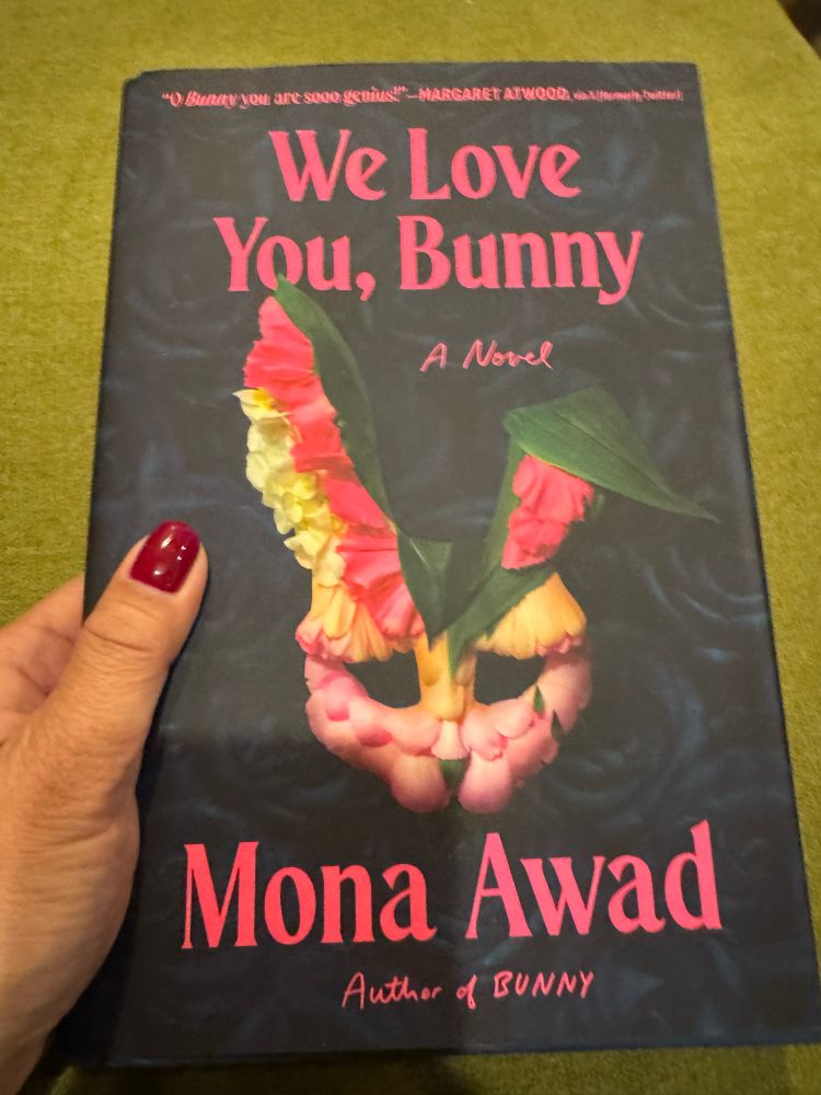 A bunny mask made of petals and leaves. Book cover for WE LOVE YOU, BUNNY by Mona Awad.