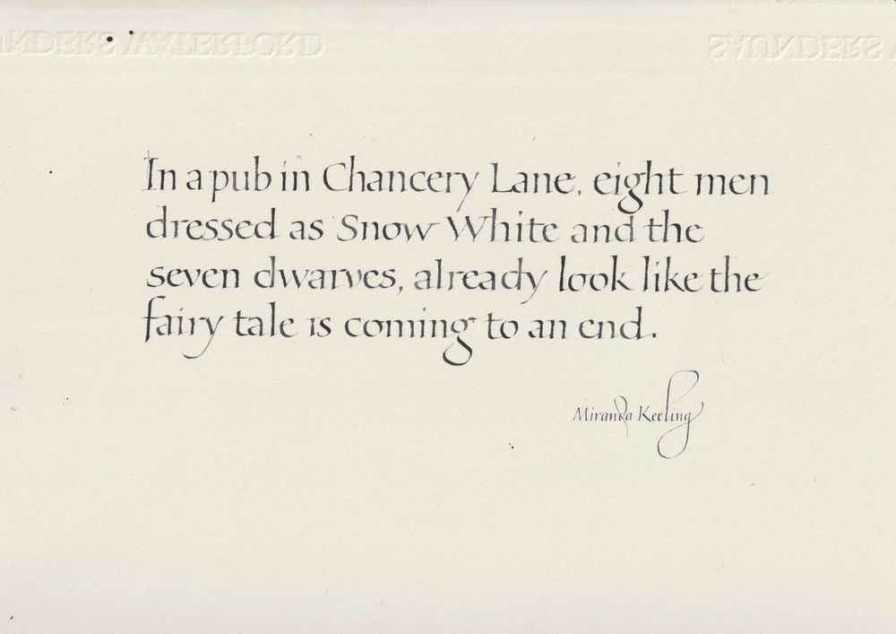 A photograph of beautiful calligraphy in black ink on cream paper of my words: In a pub in Chancery Lane, eight men dressed as Snow White and the seven dwarves, already look like the fairy tale is coming to an end.