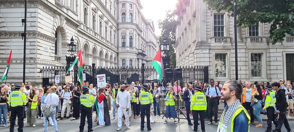Crowd at the gates of Downing Street. Palestinian flags, pots and pans, and police all there in large numbers