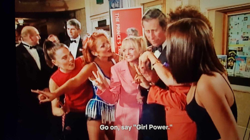 A photo of Prince Charles surrounded by the Spice Girls. They say: 'Go on, say 'Girl Power.'