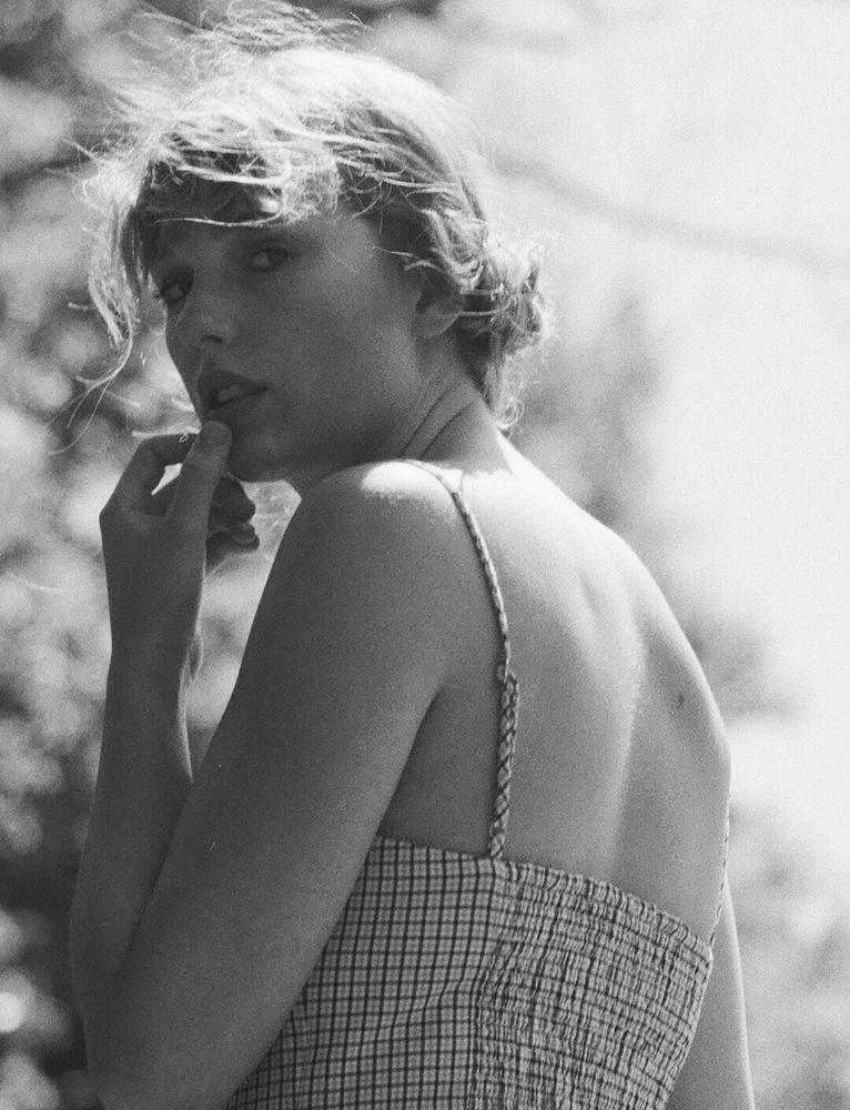 Folklore promo image with Taylor Swift wearing a dress