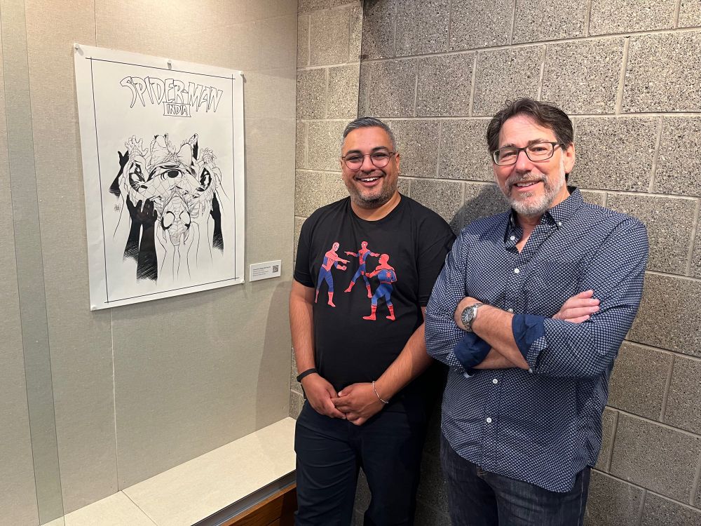 Nikesh and Adam stand next to issue 5.